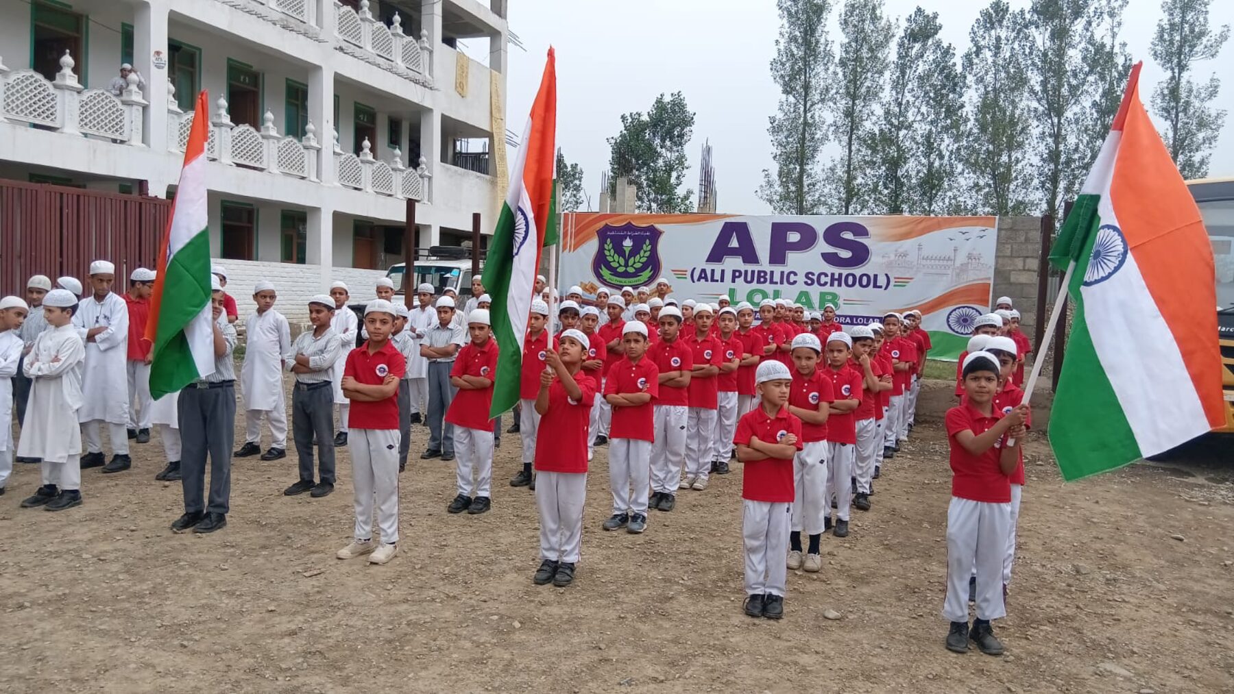 Pupils in formation with flags during a national day programme.
