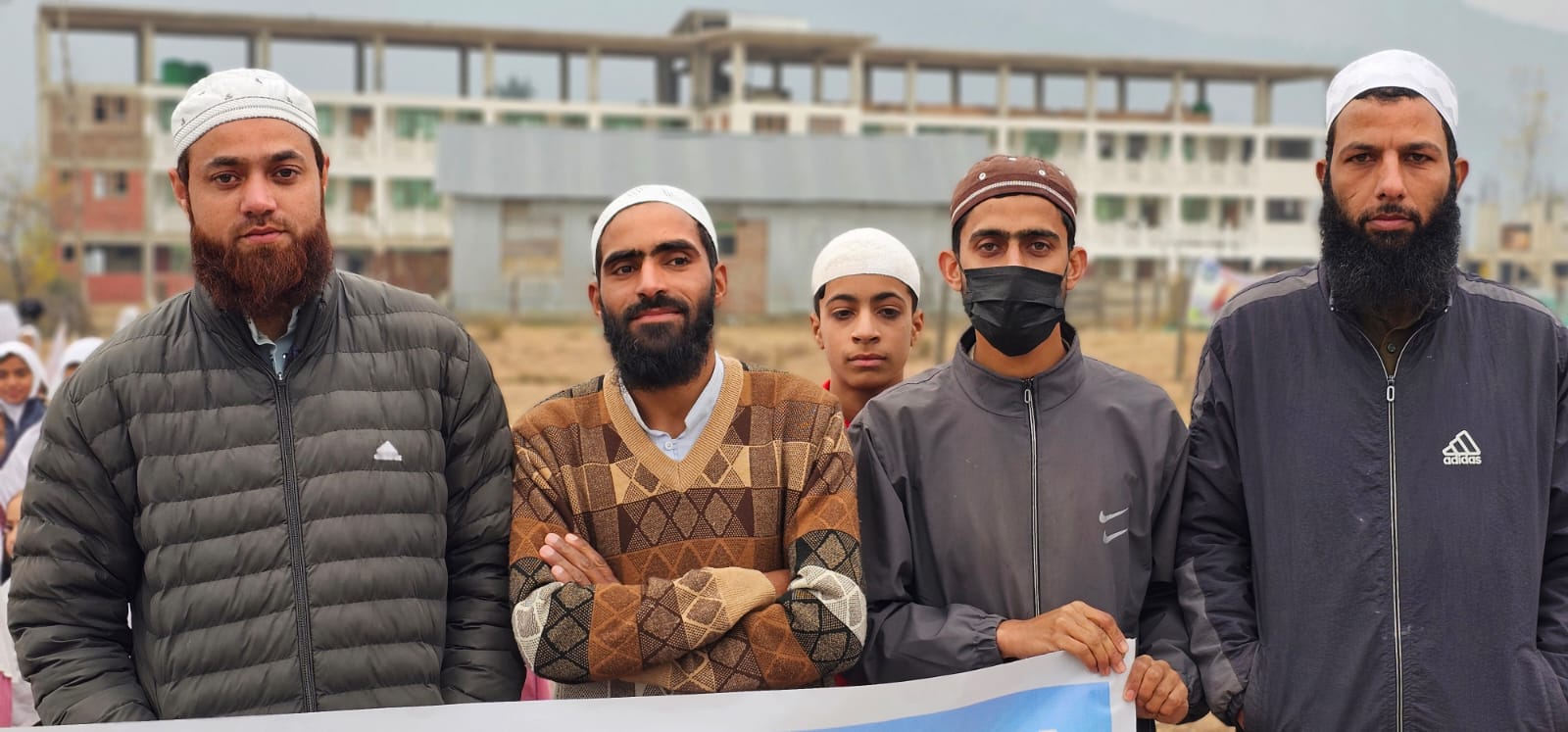APS teachers and Ulema in front of the new campus block at Naseem Bagh.